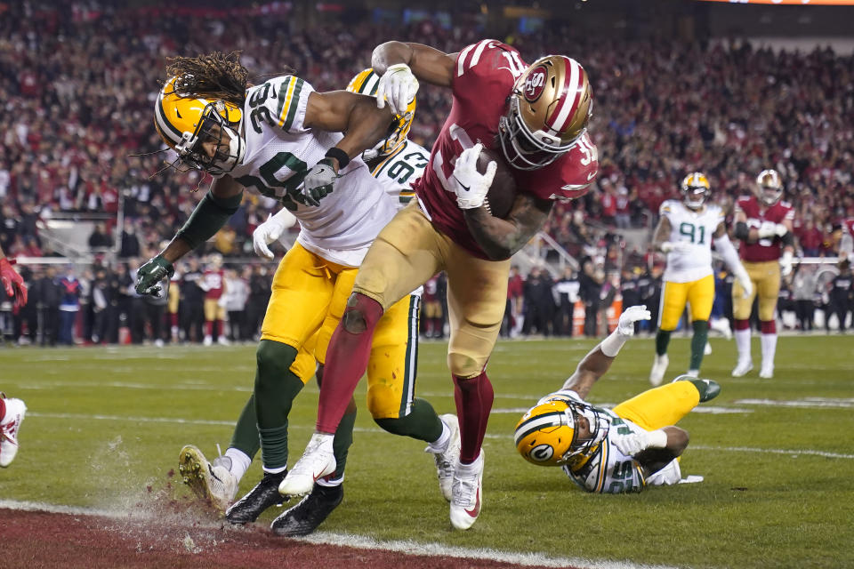 San Francisco 49ers running back Raheem Mostert, center right, scores a touchdown next to Green Bay Packers cornerback Tramon Williams during the second half of the NFL NFC Championship football game Sunday, Jan. 19, 2020, in Santa Clara, Calif. (AP Photo/Tony Avelar)