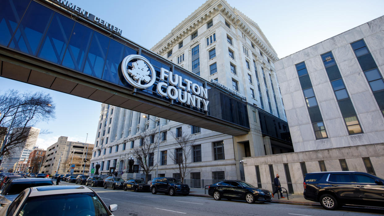 A pedestrian walkway over a city street leads to the Fulton County court.