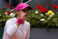 Iga Swiatek, of Poland, celebrates against Beatriz Haddad Maia, of Brazil, during the Mutua Madrid Open tennis tournament in Madrid, Tuesday, April 30, 2024. (AP Photo/Paul White)