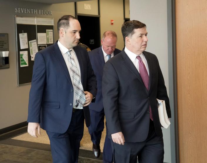 Daniel Perry, left, walks into the courtroom at his murder trial for the shooting death of Garrett Foster on April 6. Perry's attorneys on Thursday wrote a letter to the state Board of Pardons and Paroles on Thursday saying they are prepared to explain the 'tortured nature' of the case.