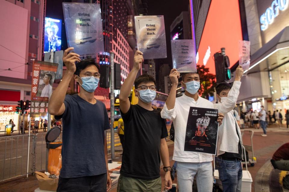 Pro-democracy activist Eddie Chu, (L), Joshua Wong Chi-fung, (2R), Owen Chow, (2R), and Lester Shum, (R), distribute leaflets in Hong Kong (EPA)