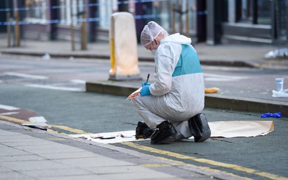 A forensic officer collecting evidence on Hurst Street, Birmingham - SnapperSK