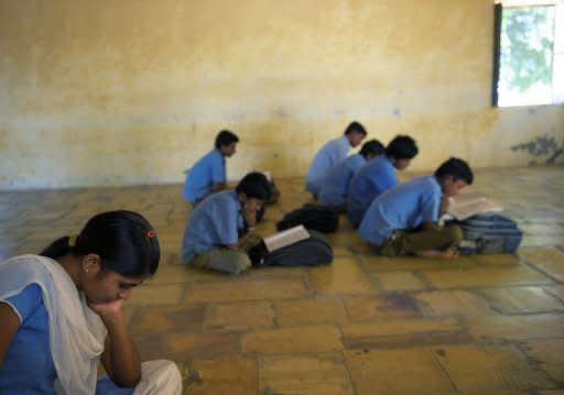 An Indian girl is seen reading her book as she sits in a classroom full of boys at a small school in Devda, in the Rajasthan state district of Jaisalmer, which has one of the worst female sex ratios in India. Almost everyone in Devda and neighbouring villages acknowledges the reality of female infanticide