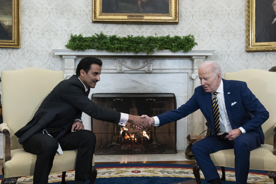 President Joe Biden, right, shakes hands with the Qatar's Emir Sheikh Tamim bin Hamad Al Thani in the Oval Office of the White House, Monday, Jan. 31, 2022, in Washington. (AP Photo/Alex Brandon)