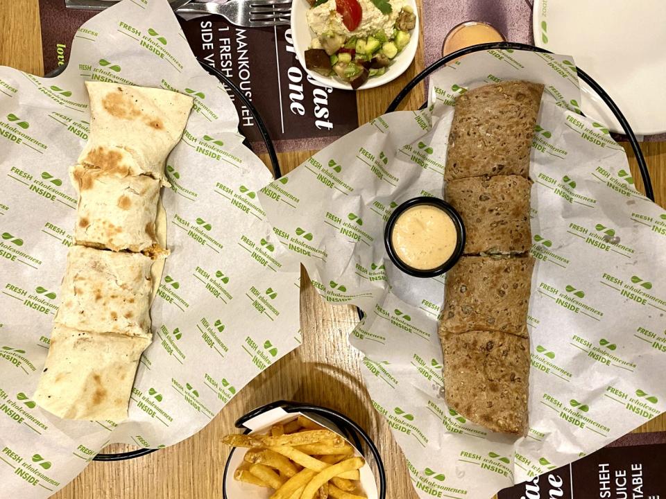 two plates of food sitting on a table at Zaatar w Zeit in Dubai