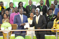 William Ruto, and his deputy Rigathi Gachagua, show the certificate after the announcement in the presidential race at the Centre in Bomas, Nairobi, Kenya, Monday, Aug.15, 2022. After last-minute chaos that could foreshadow a court challenge, Kenya’s electoral commission chairman on Monday declared Deputy President William Ruto the winner of the close presidential election over five-time contender Raila Odinga, a triumph for the man who shook up politics by appealing to struggling Kenyans on economic terms and not on traditional ethnic ones. (AP Photo/ Sayyid Abdul Azim)