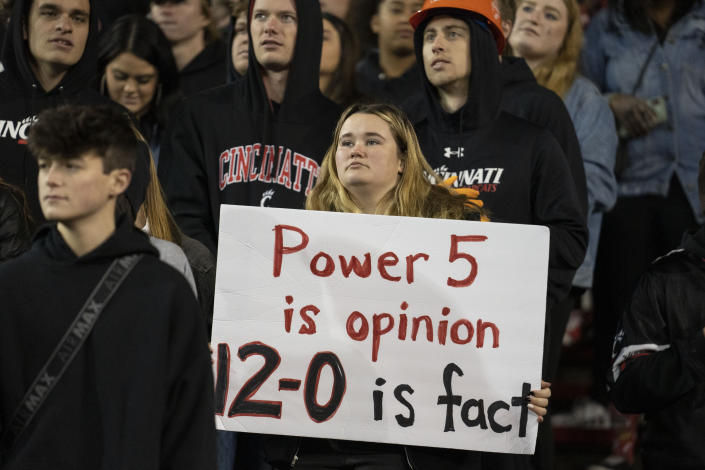 A fan holds a sign during the second half of the American Athletic Conference championship NCAA college football game between Cincinnati and Houston Saturday, Dec. 4, 2021, in Cincinnati. (AP Photo/Jeff Dean)