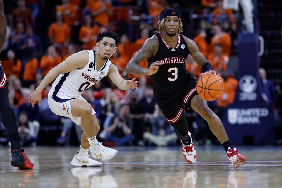 Mar 4, 2023; Charlottesville, Virginia, USA; Louisville Cardinals guard El Ellis (3) drives to the basket as Virginia Cavaliers guard Kihei Clark (0) defends in the first half at John Paul Jones Arena. Mandatory Credit: Geoff Burke-USA TODAY Sports