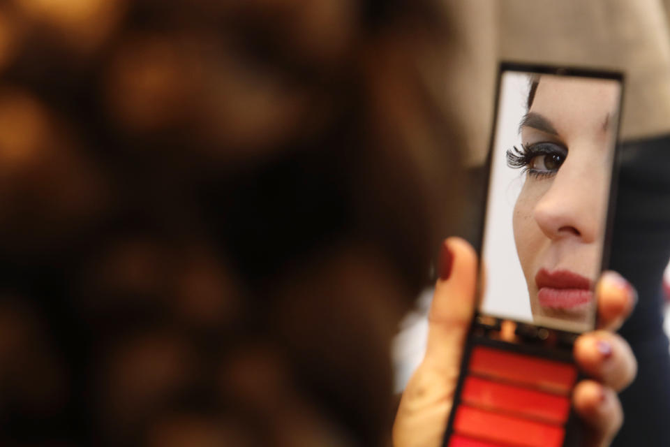 A model checks herself in a mirror backstage prior to the Franck Sorbier Haute Couture Spring/Summer 2020 fashion collection presented Tuesday Jan. 21, 2020 in Paris. (AP Photo/Christophe Ena)