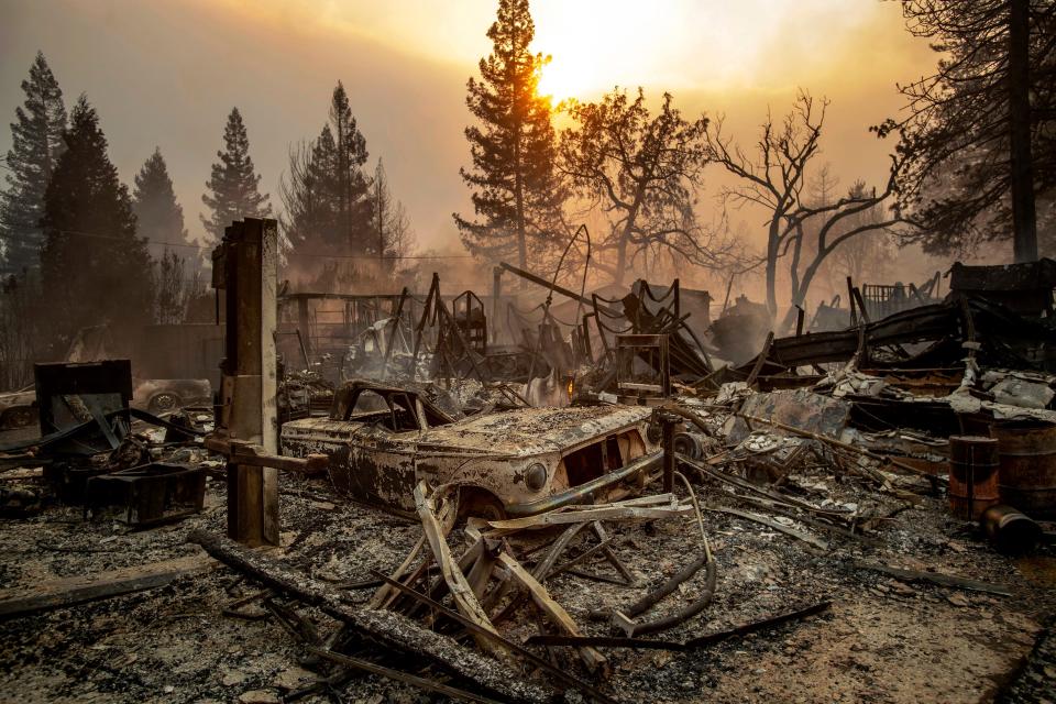 This Nov. 8, 2018, file photo shows a vintage car among debris after the Camp Fire tears through Paradise, Calif. California officials said Tuesday, Nov. 19, 2019, that crews have finished removing millions of tons of debris left by a Northern California wildfire that killed 85 people and virtually annihilated a town. The Camp Fire was the deadliest and most destructive wildfire in state history.