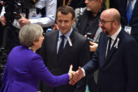 French President Emmanuel Macron and Belgian Prime Minister Charles Michel welcome British Prime Minister Theresa May during a European Union leaders summit in Brussels, Belgium, March 22, 2018. REUTERS/Eric Vidal/Pool