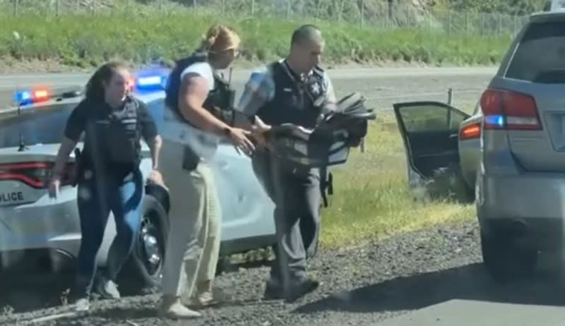 A 1-year-old boy is rescued from a car after his father, Elias Huizar, killed himself after exchanging gunfire with Oregon State Police troopers on southbound I-5 near Eugene, April 23, 2024 (Sarah Baker/Lindsay Burch)