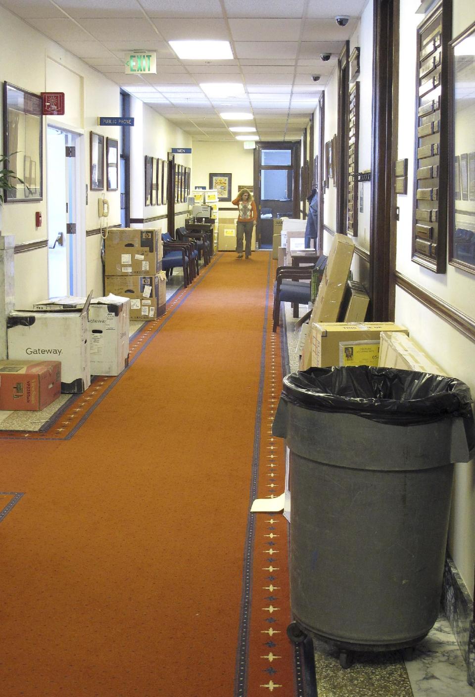 A trash can and boxes dot a corridor on the fourth floor of the state Capitol on Wednesday, April 18, 2012, in Juneau, Alaska. While the special session was just getting underway, offices were cleaning out following the regular session. (AP Photo/Becky Bohrer)