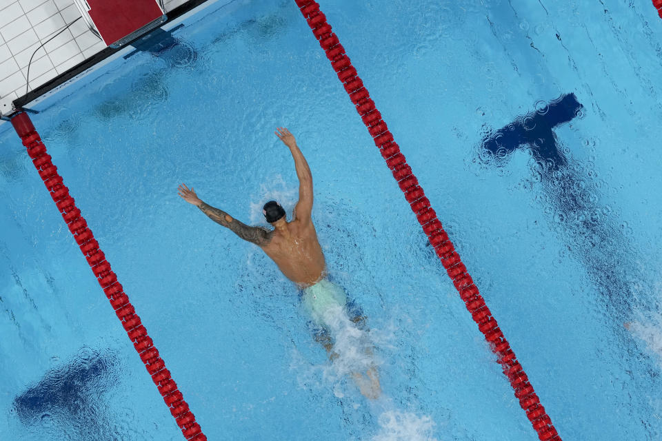 Caeleb Dressel, of the United States, swims to victory in a men's 100m butterfly semifinal at the 2020 Summer Olympics, Friday, July 30, 2021, in Tokyo, Japan. (AP Photo/Jeff Roberson)