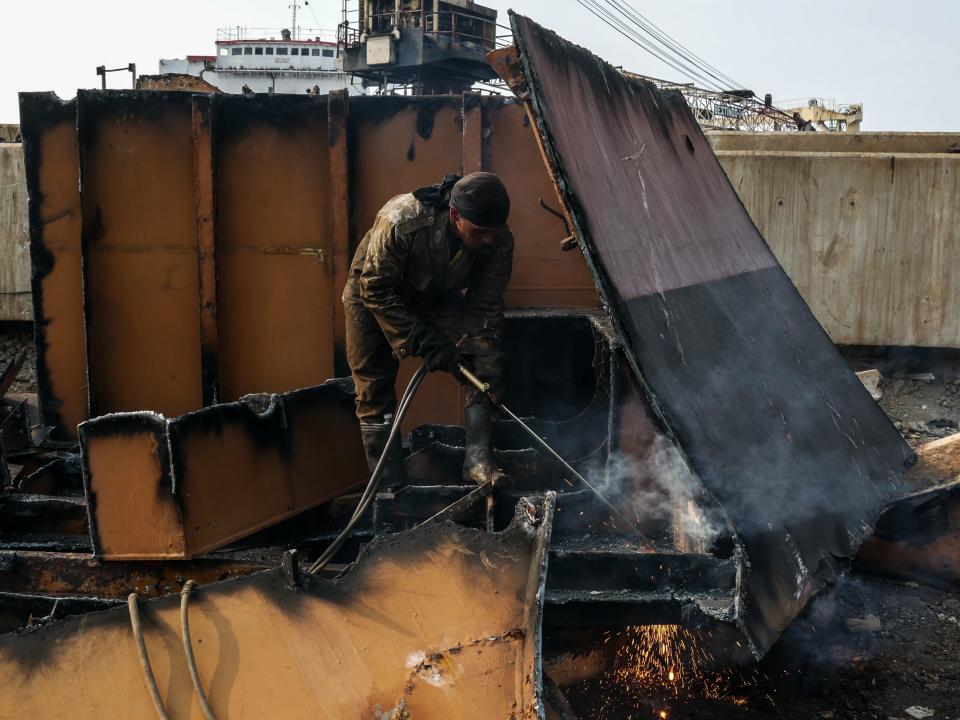 A worker welds a part of an old Ship to get a metal at a shipbreaking yards Kalibaru in Jakarta, Indonesia on September 27, 2018.