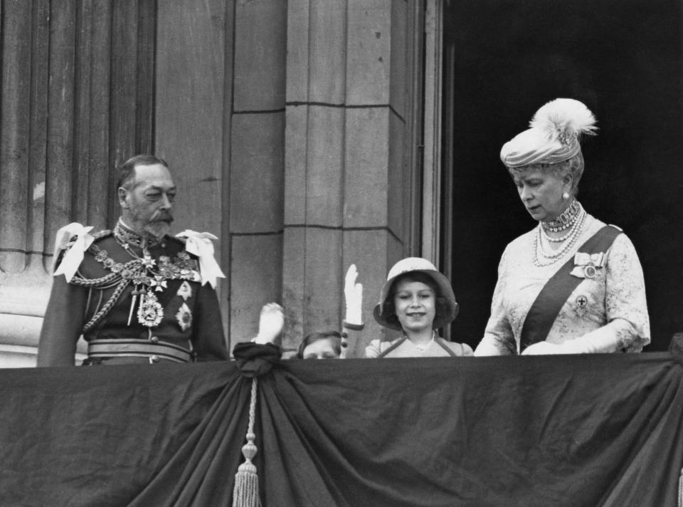 The Queen as a child waving from the balcony of Buckingham Palace in London