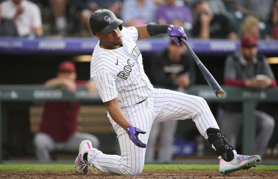 Colorado Rockies' Elias Diaz reacts after swinging at a pitch from Arizona Diamondbacks starting pitcher Merrill Kelly during the fifth inning of a baseball game Friday, July 1, 2022, in Denver. (AP Photo/David Zalubowski)