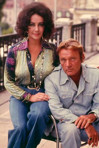 <p>Bob Penn/Sygma/Sygma via Getty</p> Elizabeth Taylor and Richard Burton pose in casual wear