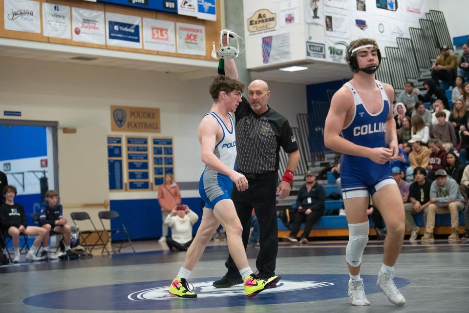 Poudre wrestler Banks Norby raises a hand after defeating Fort Collins' Tristan Anthony during a city rivalry wrestling dual on Jan. 18 at Poudre High School in Fort Collins. The Impalas won 53-17.