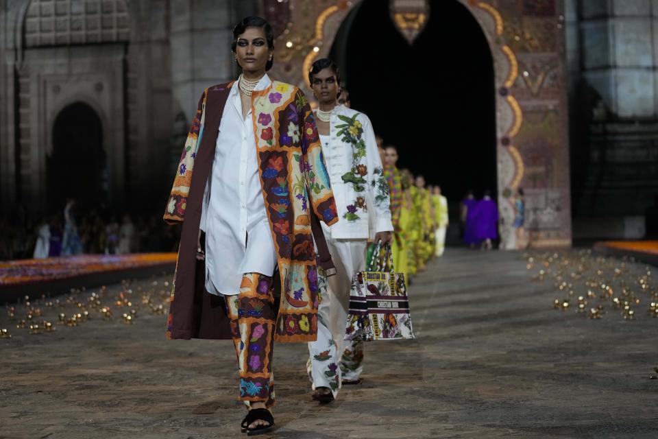 Models display creations for the Dior Pre-Fall 2023 collection at the Gateway of India landmark monument in Mumbai, India, Thursday, March 30, 2023. (AP Photo/Rafiq Maqbool)