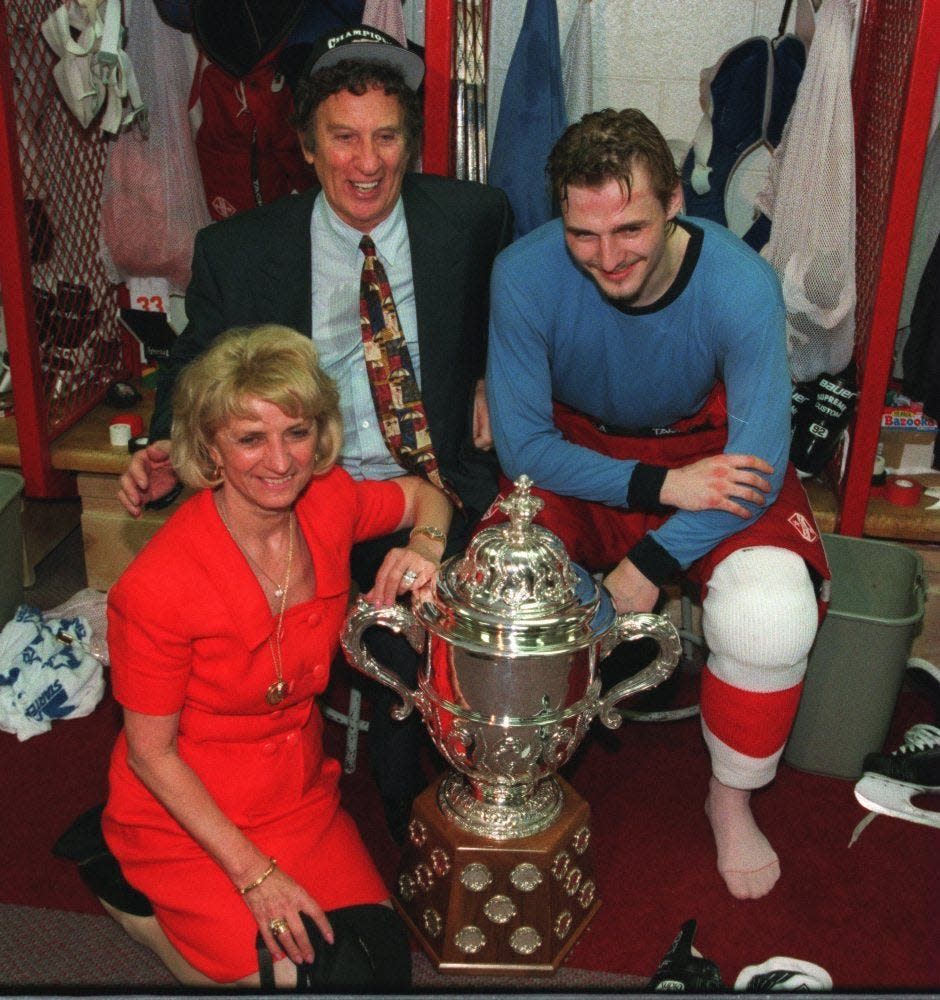 Mike and Marian Ilitch with Sergei Fedorov in the locker room with the trophy they won for winning the Western Conference at Joe Louis Arena in Detroit on June 11, 1995.