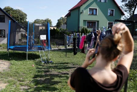 Katarzyna Ichnowska looks at her children play in Nowa Karczma