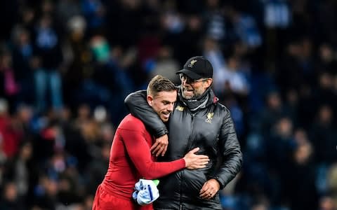 Jurgen Klopp embraces Jordan Henderson - Jurgen Klopp said it was "really special" to be in the Champions League semi-final for the second year in a row - Credit: Getty Images