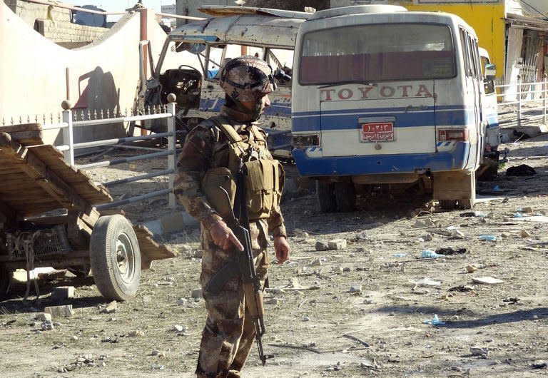 A security officer inspects the site of an explosion in Kirkuk, Iraq, on January 16, 2013. The attack comes as Iraq grapples with a long-running political dispute, with Prime Minister Nuri al-Maliki facing several protests