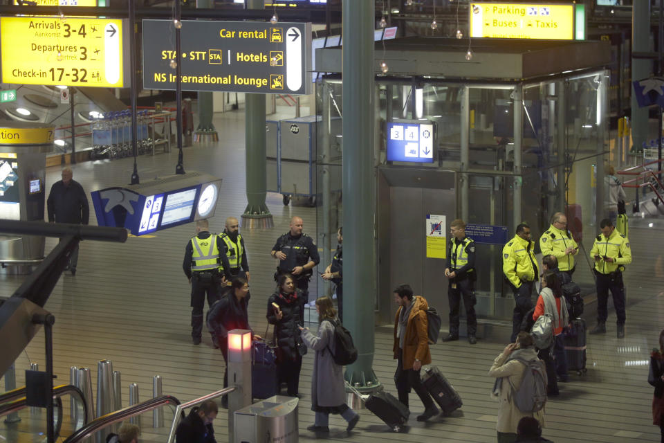 Dutch police mill about after a threat at Schiphol airport in Amsterdam, Netherlands, Wednesday, Nov. 6, 2019. Dutch military police say that all passengers and crew are safely off a plane at the center of a security alert at Amsterdam's Schiphol Airport. The military police service earlier said they were responding to a suspicious situation at the airport on the outskirts of Amsterdam. (AP Photo/Peter Dejong)