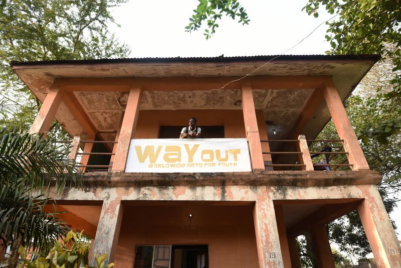 Way Out member Milton Kanu stands on the balcony of the eponymous media studio in Freetown,