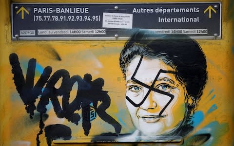 A vandalised mailbox with a swastika covering a portrait of the late Holocaust survivor and renowned French politician Simone Veil is seen before its renovation in Paris - Credit: BENOIT TESSIER/REUTERS