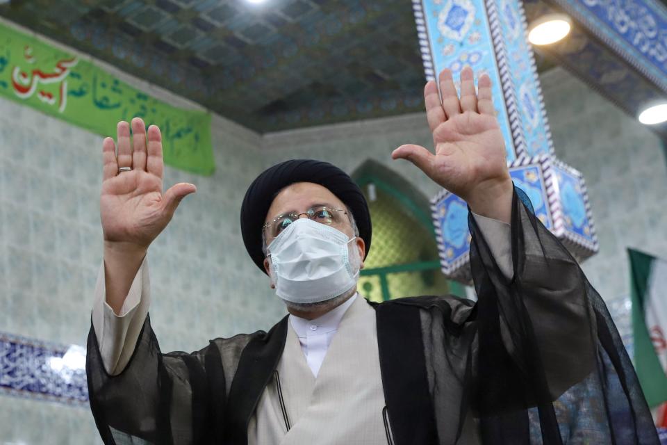 Presidential candidate Ebrahim Raisi gestures after casting his vote (VIA REUTERS)