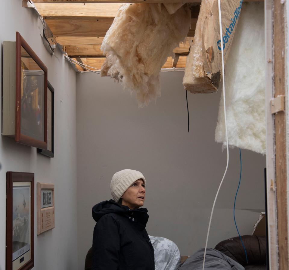 First lady Maria Lee looks up at the damage left in one Maritza Pearl’s home in Clarksville, Tenn., Sunday, Dec. 10, 2023. Tornadoes struck Middle Tennessee on Saturday, killing at least six people and leaving more than 160,000 Middle Tennessee residents without power.