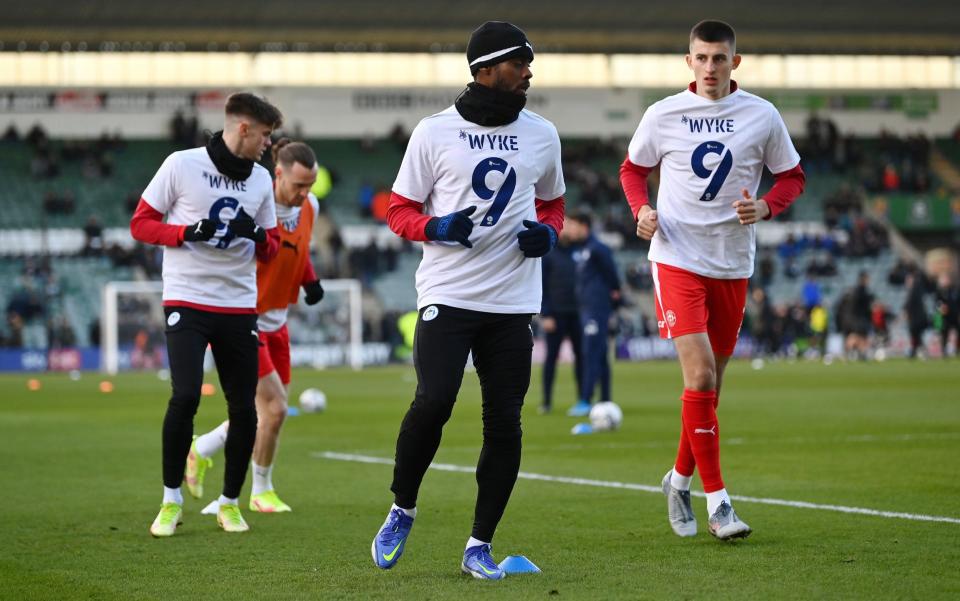 Wigan's players warmed up in 'Wyke 9' shirts before their game against Plymouth - GETTY IMAGES