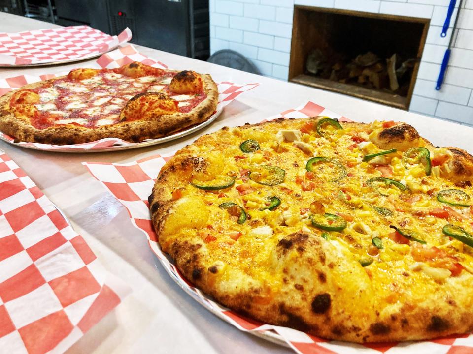 The Margherita, left, and Santa Fe are among the many specialty pizzas available at Russo's Wood Fired Pizza in Zanesville. The business, which opened in 2017, will celebrate its fifth year in business later this year.