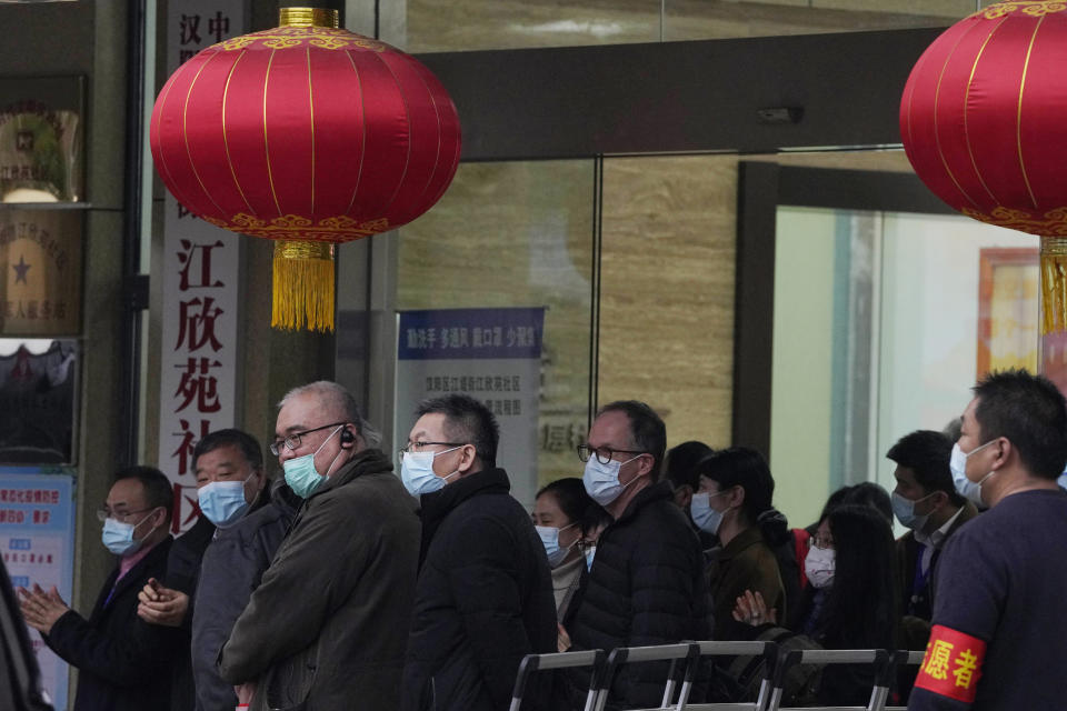 Peter Ben Embarek of the World Health Organization team, center, leaves after a field visit at the Service Center for Party Members and Residents of Jiangxinyuan Community in Wuhan, China, Thursday, Feb. 4, 2021. (AP Photo/Ng Han Guan)