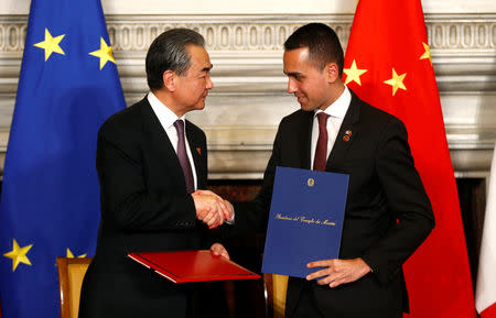 Chinese Foreign Minister Wang Yi and Italian Minister of Labor and Industry Luigi Di Maio shake hands after signing trade agreements at Villa Madama in Rome, Italy March 23, 2019. REUTERS/Yara Nardi