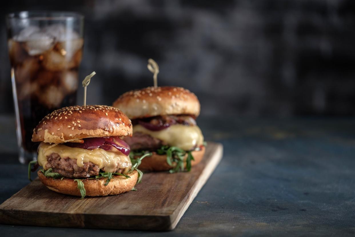 Homemade tasty hamburger with beef, cheese and caramelized onions. Street food, fast food. Copyspace.