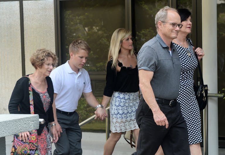 Family members of US scientist Shane Todd return to the subordinate courts after a lunch break in Singapore, on May 15, 2013. Singapore has asked the parents of Todd, found hanged last year in the city-state, to provide evidence for their claim that he was murdered, rather than committing suicide as medical experts said