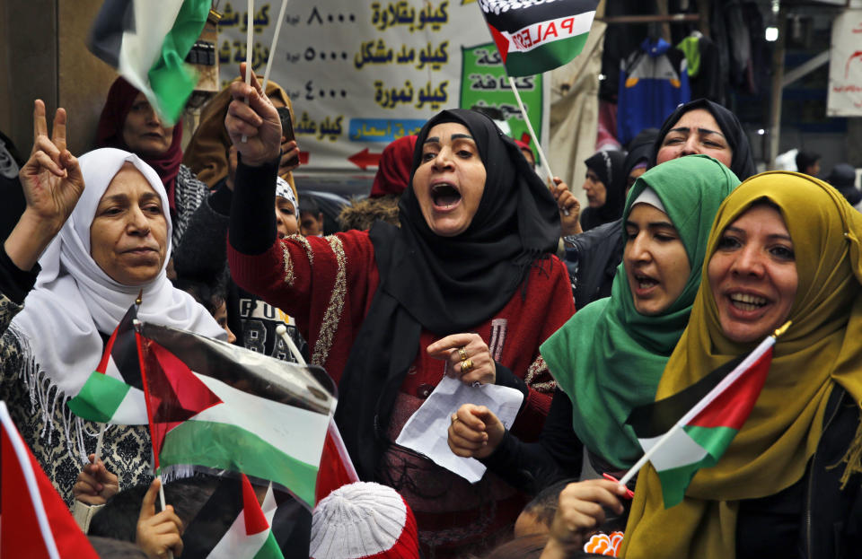 <p>Palestinian women chant slogans as they hold Palestinian flags during a sit-in in the Bourj al-Barajneh Palestinian refugee camp, in Beirut, Lebanon, Wednesday, Dec. 6, 2017. (Photo: Bilal Hussein/AP) </p>