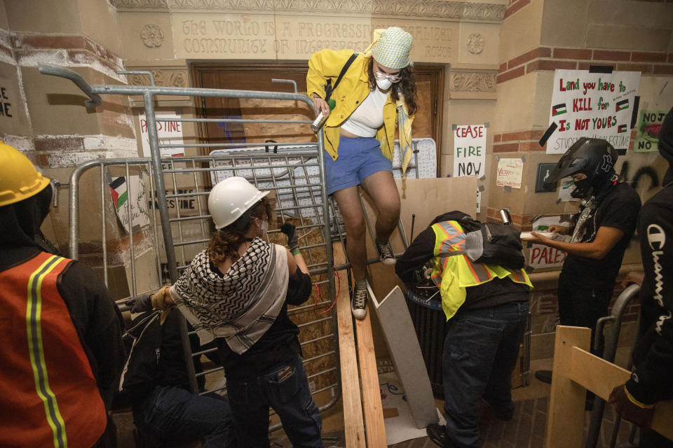 FILE - Pro-Palestinian demonstrators block the entrance to a building on the UCLA campus Wednesday, May 1, 2024, in Los Angeles. (AP Photo/Ethan Swope, File)