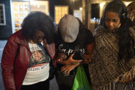 Denise Friday, from left, Tracy Shand and Tawanda Jones pray together during a welcome dinner for the annual Families United 4 Justice Network Conference, hosted by the Black Lives Matter Global Network Foundation at its mansion in the Studio City neighborhood of Los Angeles, Thursday, Sept. 28, 2023. A national Black Lives Matter nonprofit that purchased a sprawling California mansion with donated funds recently opened the property to dozens of families who lost loved ones in incidents of police violence. (AP Photo/Jae C. Hong)