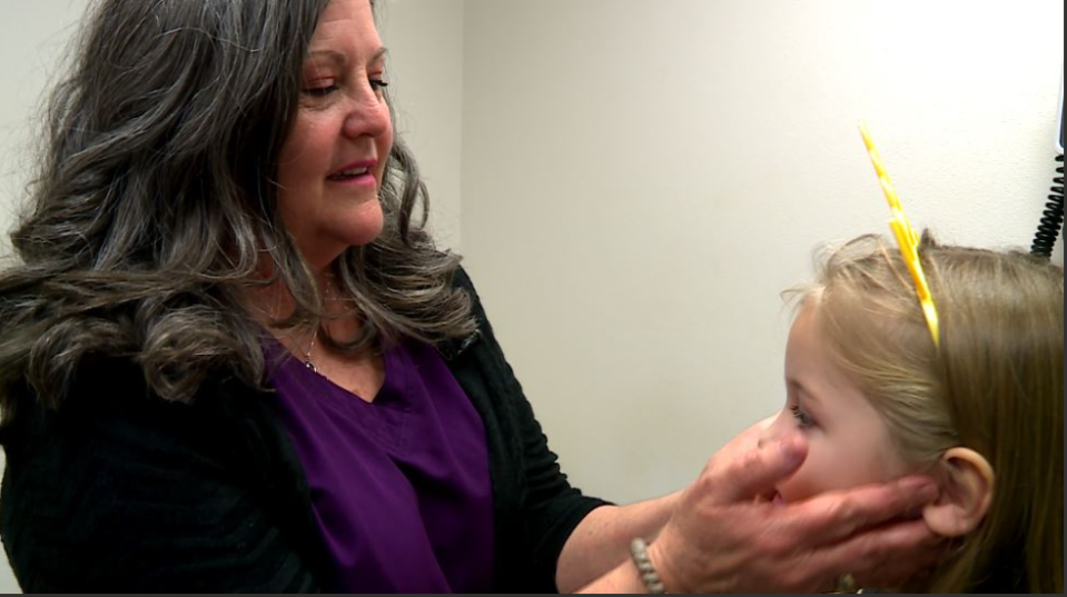 Nurse Judy Vire examines patient