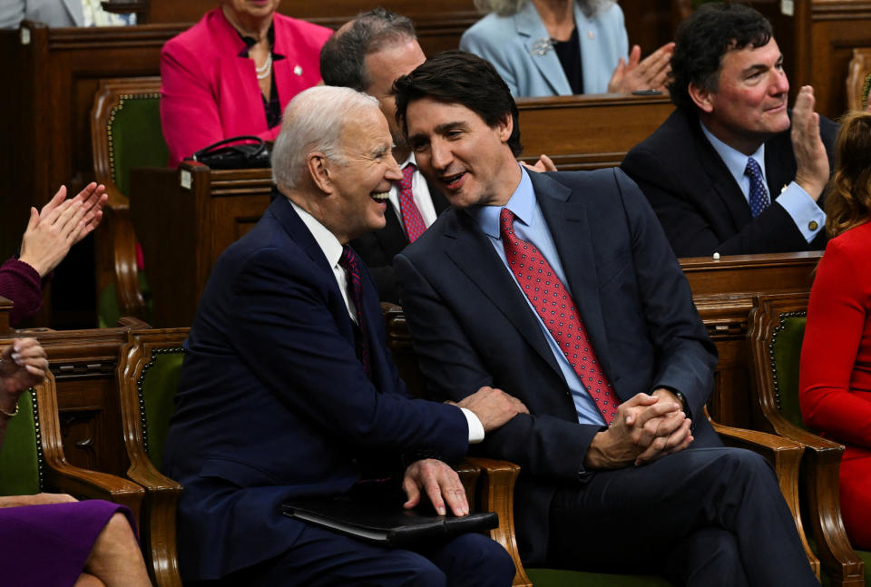 U.S. President Joe Biden and Canadian Prime Minister Justin Trudeau speak as they attend an address to the Canadian Parliament, in Ottawa, Canada, Mach 24, 2023. Kenny Holston/Pool via REUTERS