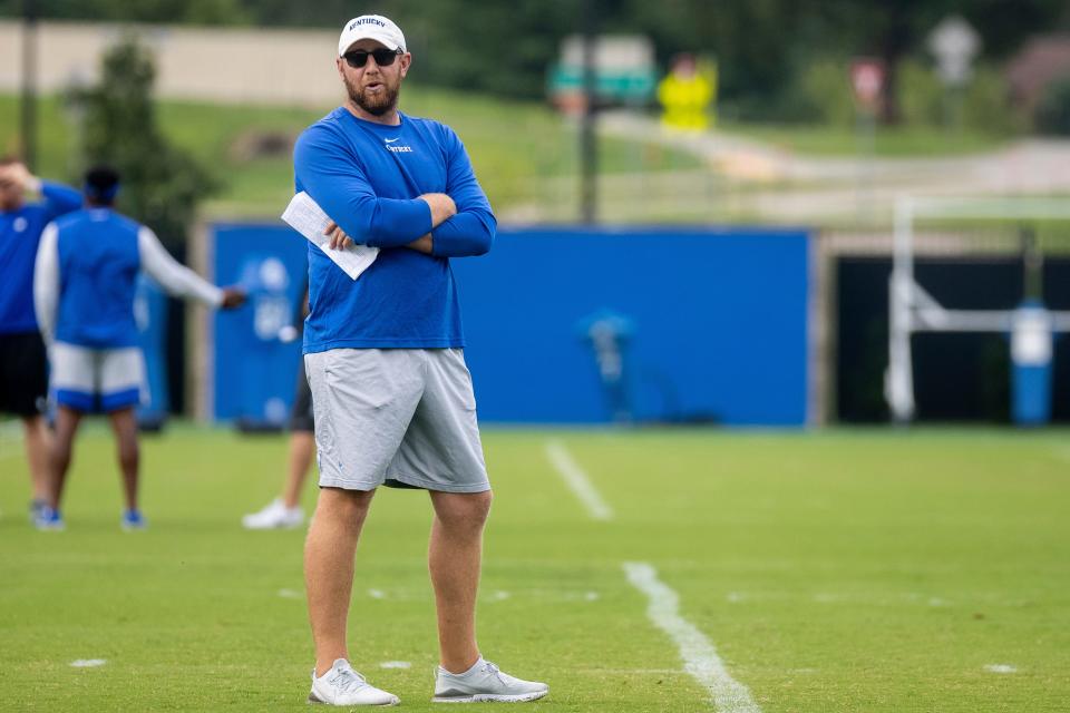 Kentucky offensive coordinator Liam Coen runs a drill during a practice in Lexington, Ky., Tuesday, Aug. 17, 2021.