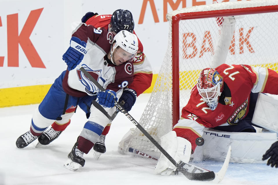 Colorado Avalanche left wing Zach Parise (9) attempts a shot against Florida Panthers goaltender Sergei Bobrovsky (72) and defenseman Niko Mikkola (77) during the second period of an NHL hockey game, Saturday, Feb. 10, 2024, in Sunrise, Fla. (AP Photo/Wilfredo Lee)