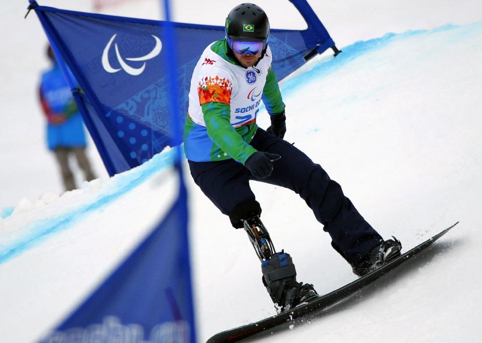 Andre Pereira, of Brazil, competes during the men's para-snowboard cross, standing event at the 2014 Winter Paralympic, Friday, March 14, 2014, in Krasnaya Polyana, Russia. (AP Photo/Dmitry Lovetsky)