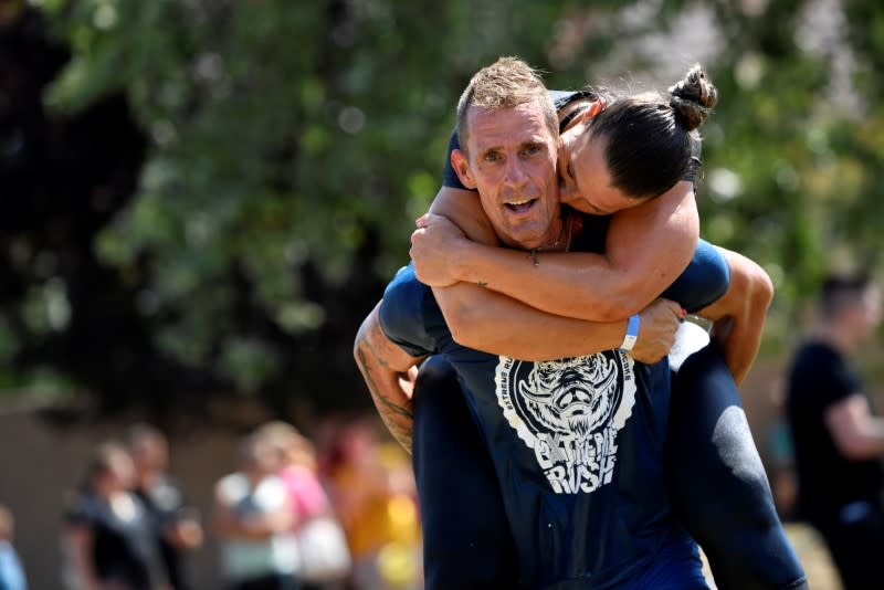 Participants compete in a wife-carrying championship