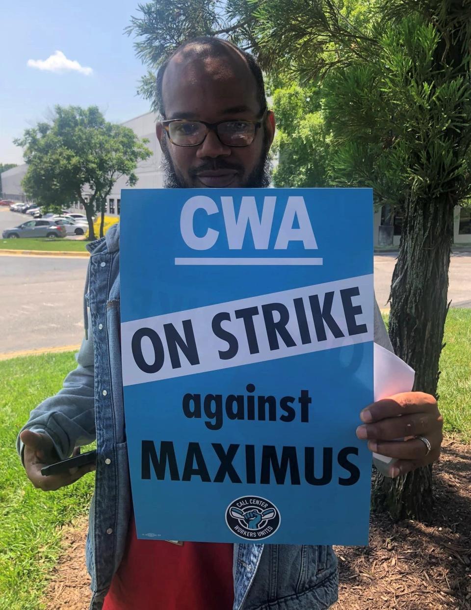 Maximus call center employee Christopher Carty of Chester on strike in Chester, Va.