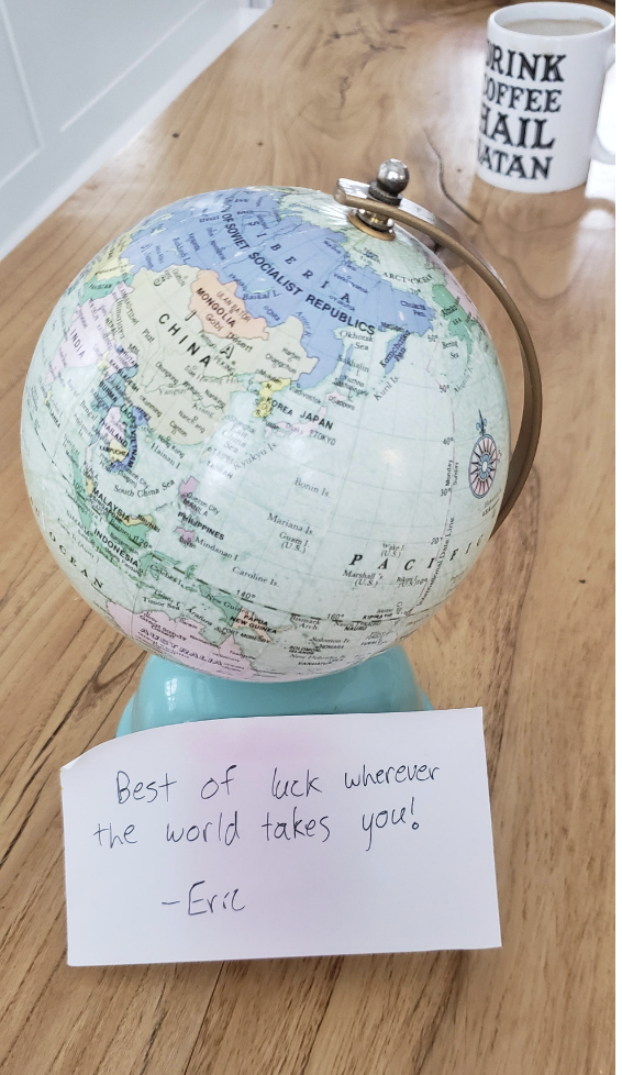 A globe with note: "Best of luck wherever the world takes you!: